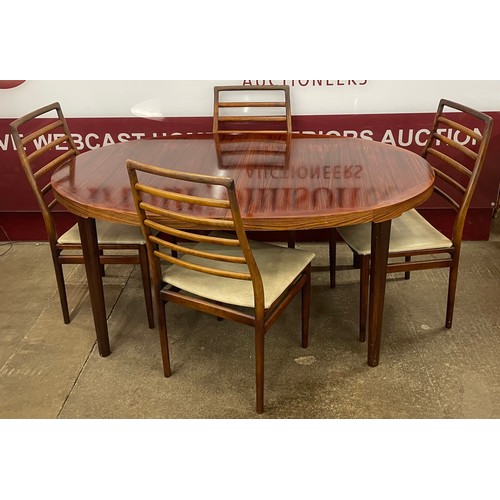 6A - A Danish Rosengaarden Hojte rosewood oval extending dining table and four chairs, designed by C.J. R... 