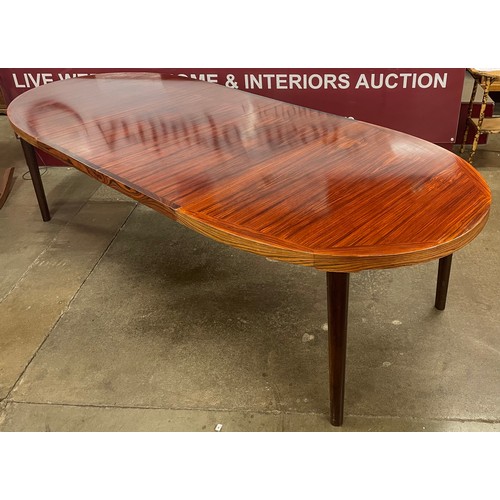 6A - A Danish Rosengaarden Hojte rosewood oval extending dining table and four chairs, designed by C.J. R... 