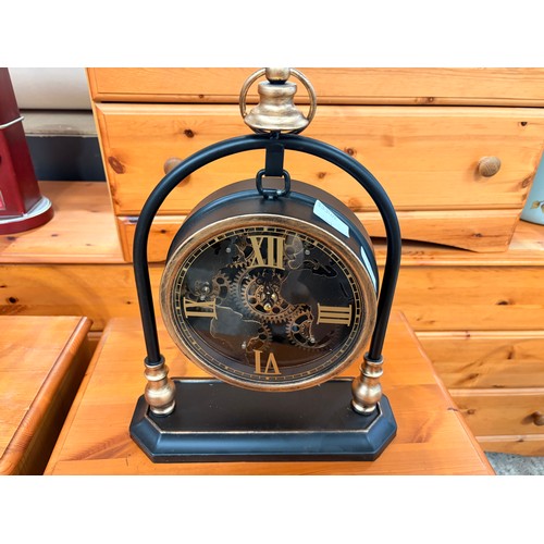 3025 - A black and gold effect moving gear mantle clock