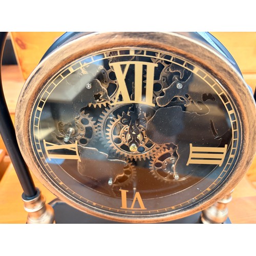 3025 - A black and gold effect moving gear mantle clock