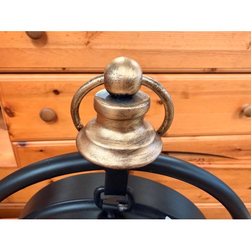 3025 - A black and gold effect moving gear mantle clock