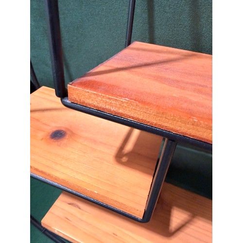 3027 - A circular framed three tier wall shelf