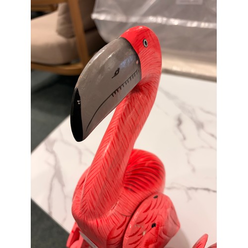 3068 - A set of three wooden sitting flamingo ornaments