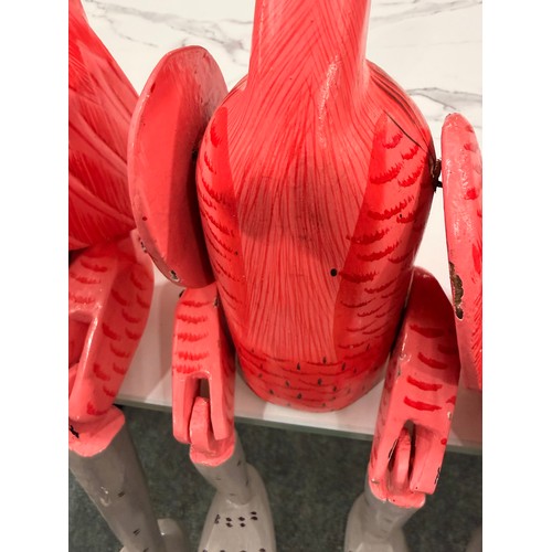 3068 - A set of three wooden sitting flamingo ornaments