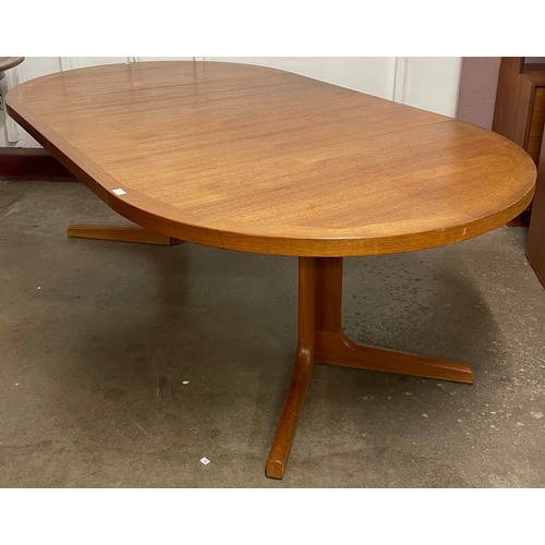 10 - A teak circular extending dining table and six chairs