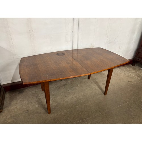 66 - A Gordon Russell teak oval extending dining table and eight chairs
