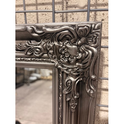 3109 - An oak silver painted carved framed mirror