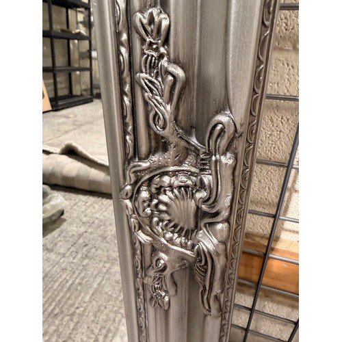 3109 - An oak silver painted carved framed mirror