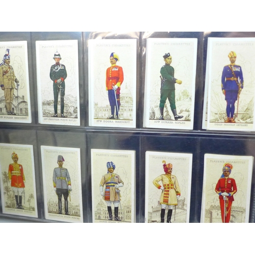 2037 - An album of cigarette card sets all complete, to include; John Player Drum Banners & Cap Badges, Joh... 