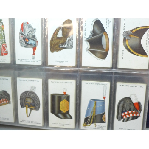 2037 - An album of cigarette card sets all complete, to include; John Player Drum Banners & Cap Badges, Joh... 