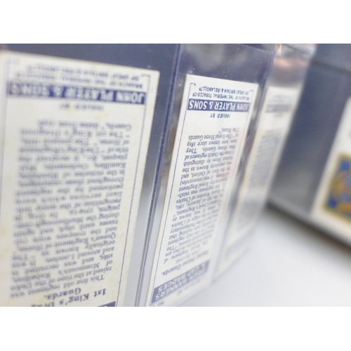 2037 - An album of cigarette card sets all complete, to include; John Player Drum Banners & Cap Badges, Joh... 