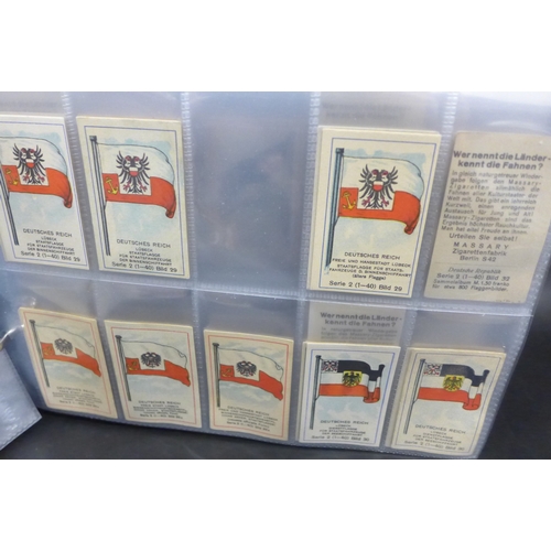 2043 - An album of assorted German Massary cigarette cards part sets of various series, all flags