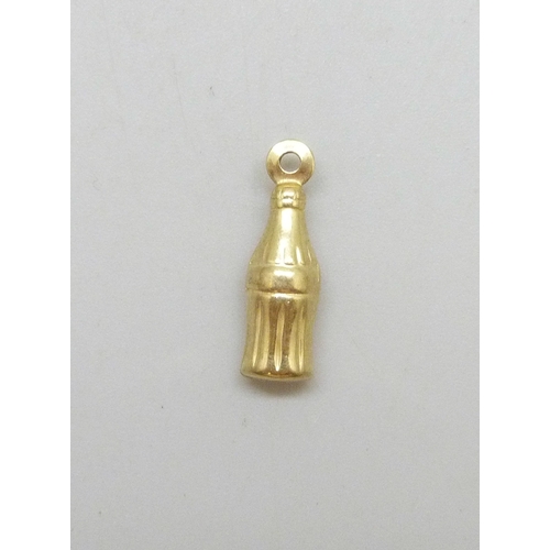 7005 - A yellow metal charm in the form of a Coca Cola style bottle, 0.4g, 1.6cm