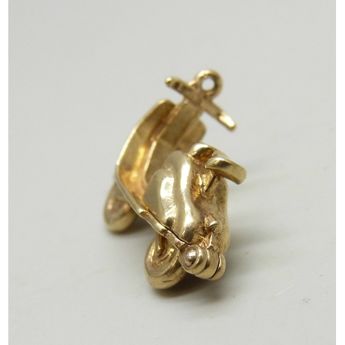 7009 - A 9ct gold charm in the form of a scooter or moped, the back opens, hallmarked, 4.2g, 2.2cm