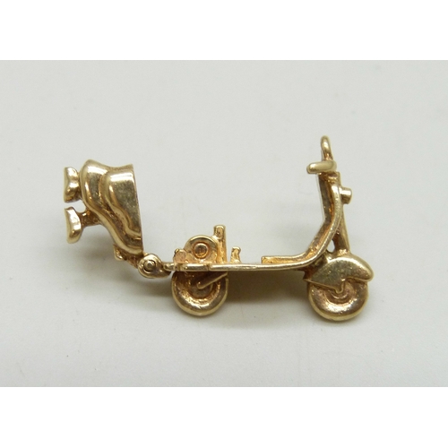 7009 - A 9ct gold charm in the form of a scooter or moped, the back opens, hallmarked, 4.2g, 2.2cm
