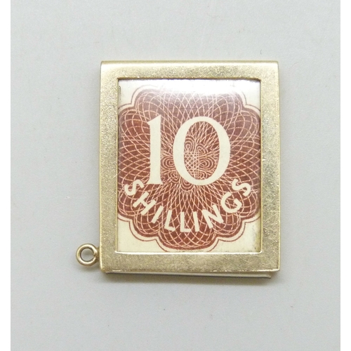 7013 - A 9ct gold framed 10 shilling note charm, hallmarked, 2.8g without the note or transparent cover,