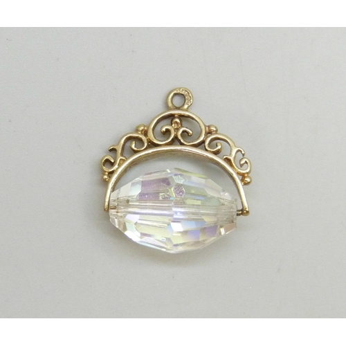 7022 - A 9ct gold fob set with an aurora borealis glass swivel, hallmarked, 3.4g, 1.8cm