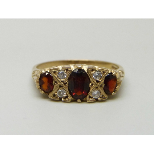 7031 - A 9ct gold, garnet and white stone ring, 2.5g, Q