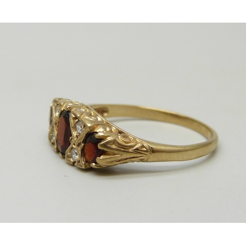 7031 - A 9ct gold, garnet and white stone ring, 2.5g, Q