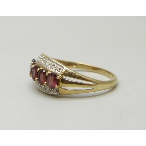 7036 - A 9ct gold, garnet and diamond ring, 2.4g, S
