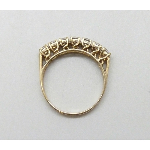 7042 - A 9ct gold ring set with seven cubic zirconia stones, 2.4g, P