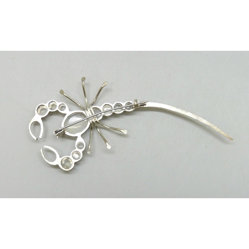 7047 - A Victorian scorpion brooch set with moonstones, 7.4cm