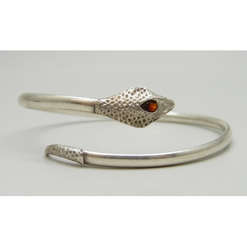 7048 - A silver snake design bangle set with garnets, 7g, 6.1 x 5.1cm