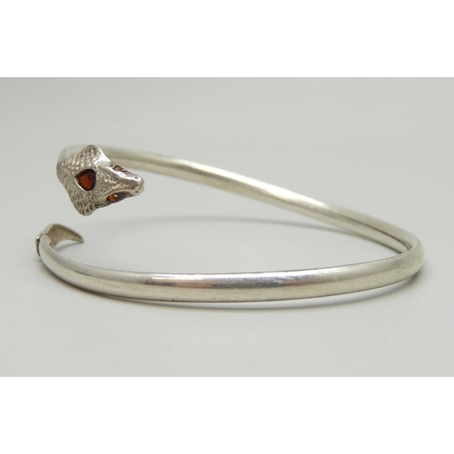7048 - A silver snake design bangle set with garnets, 7g, 6.1 x 5.1cm