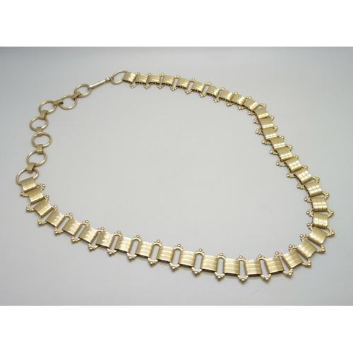 7058 - A Victorian style gold plated book chain, approximately 93cm