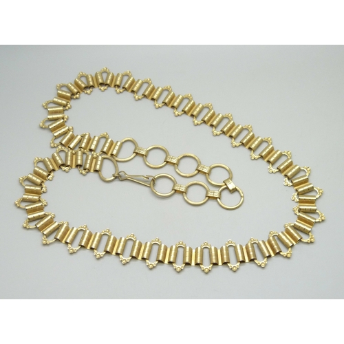 7058 - A Victorian style gold plated book chain, approximately 93cm