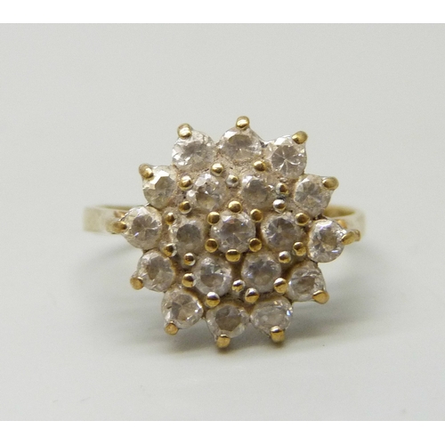 7059 - A 9ct gold cubic zirconia cluster ring, band slightly misshapen, 2.4g, K/L