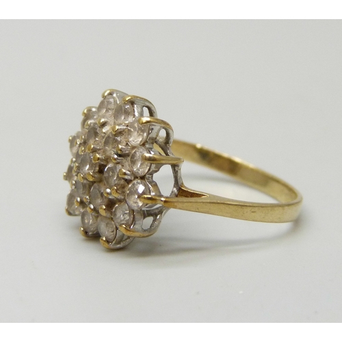 7059 - A 9ct gold cubic zirconia cluster ring, band slightly misshapen, 2.4g, K/L