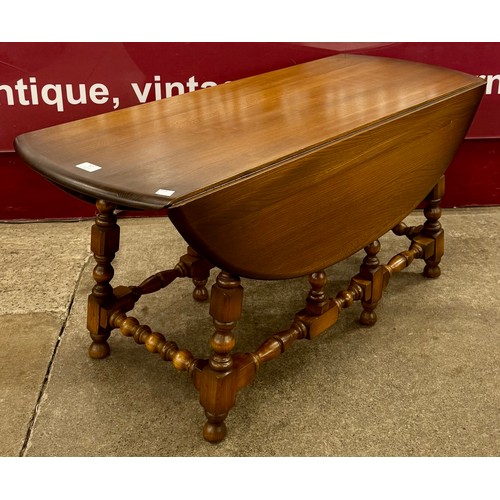 100 - An Ercol Golden Dawn ash drop-leaf coffee table