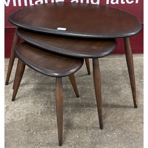 64 - An Ercol Golden Dawn elm and beech pebble nest of tables
