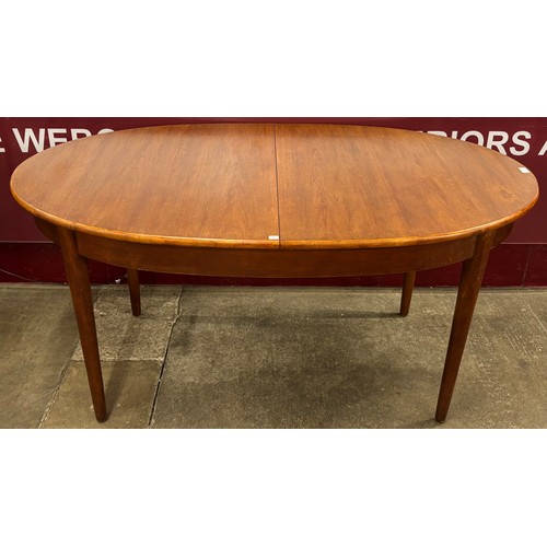 69 - A Jentique teak oval extending dining table