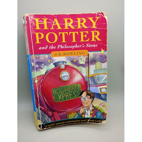 2075 - J. K. Rowling; Harry Potter and the Philosopher's Stone, a first edition first printing soft cover b...