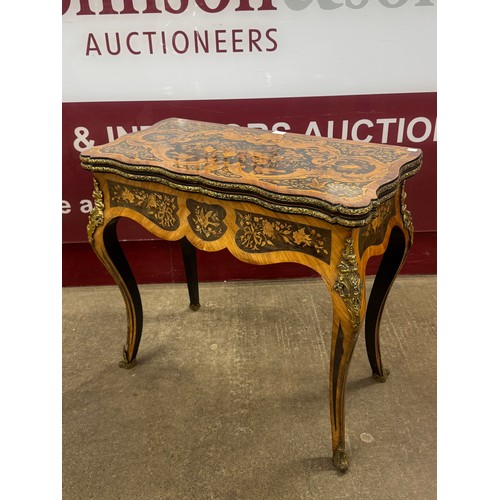 85 - A French Louis XV style marquetry inlaid walnut and gilt metal mounted fold-over games table