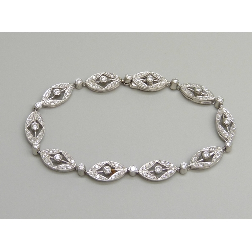 7116 - An 18ct white gold and diamond bracelet, hallmarked, 15.3g, 17.5cm