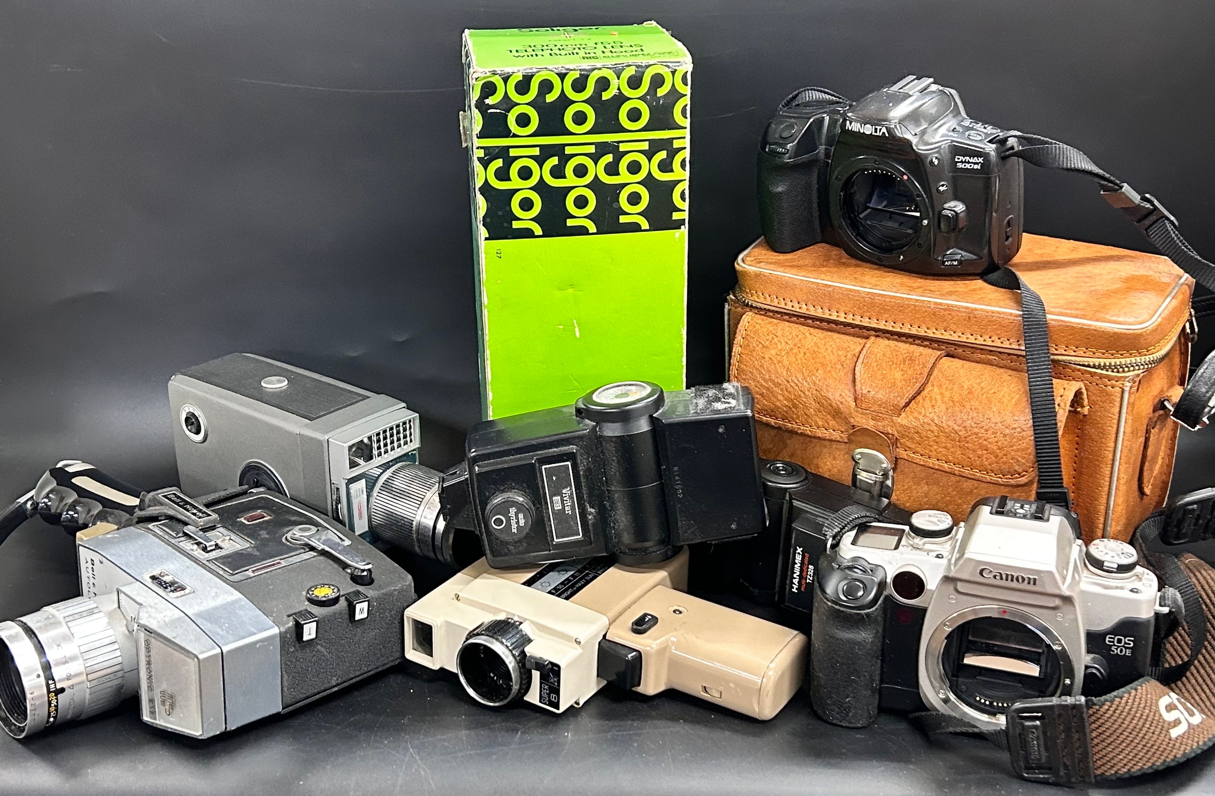 A collection of vintage cameras and lenses including Bell & Howell ...