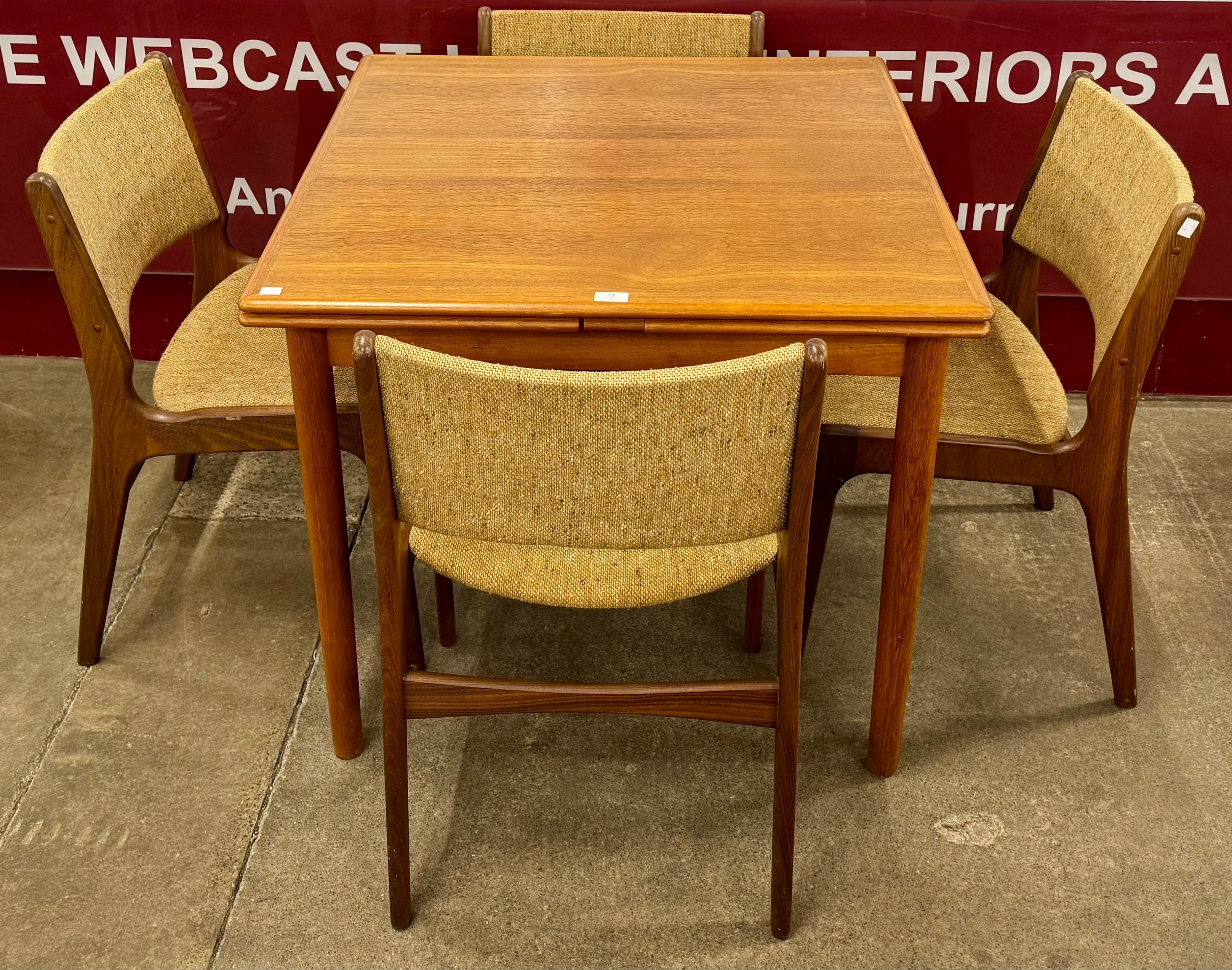 A Danish teak draw-leaf dining table and four chairs