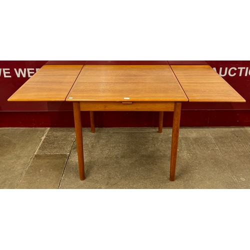 A Danish teak draw-leaf dining table and four chairs