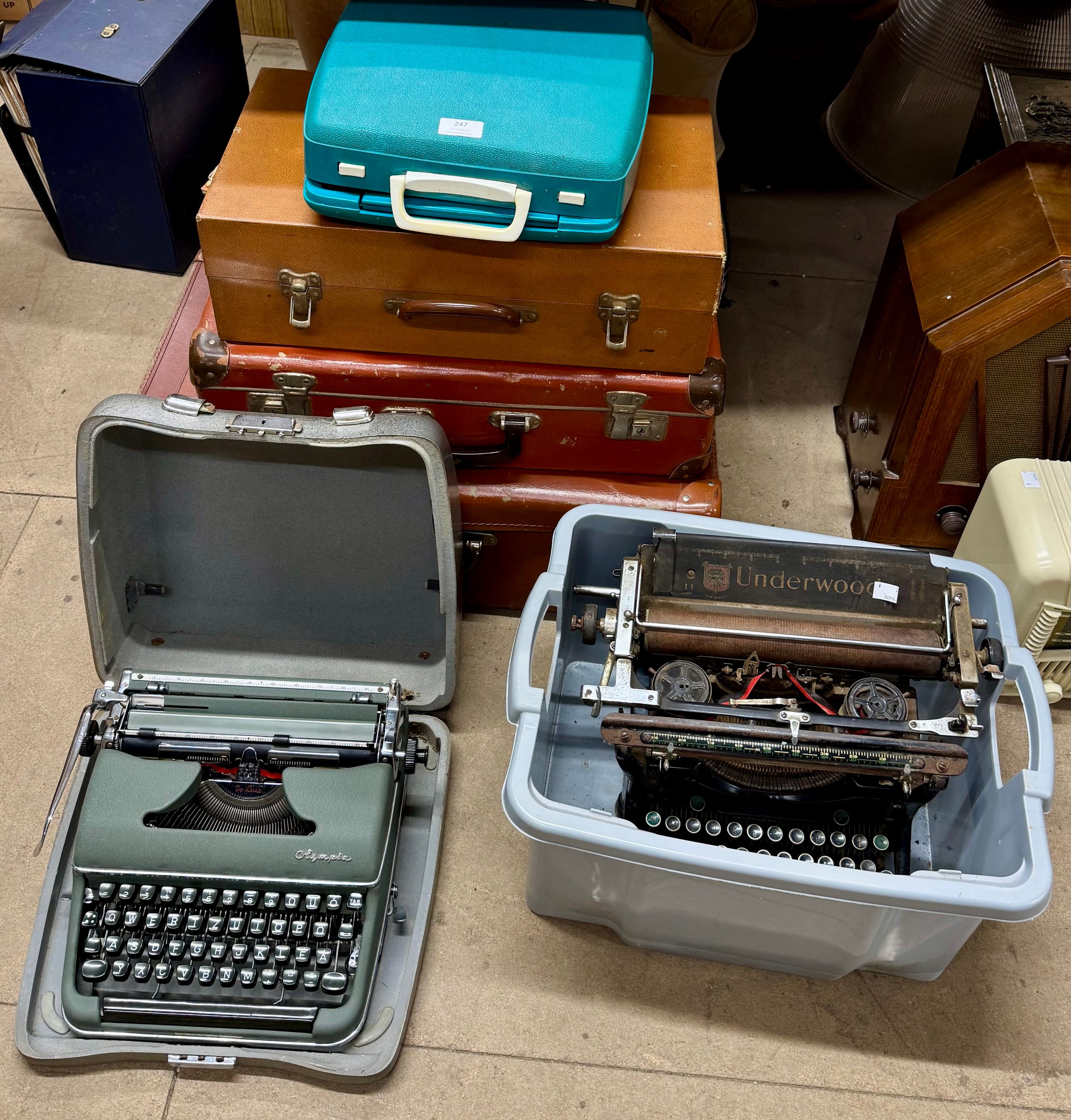 Three travel cases and typewriter