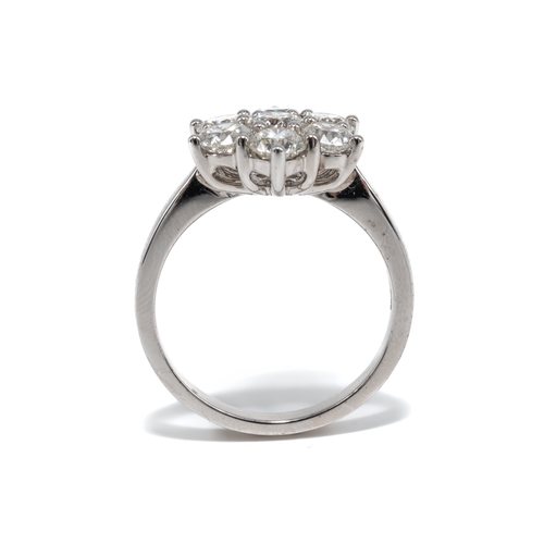 7 - An 18ct white gold and diamond seven-stone floral cluster ring, set with round brilliant-cut diamond... 