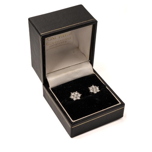 8 - A pair of 18ct white gold and diamond floral cluster stud earrings, each earring set with seven roun... 