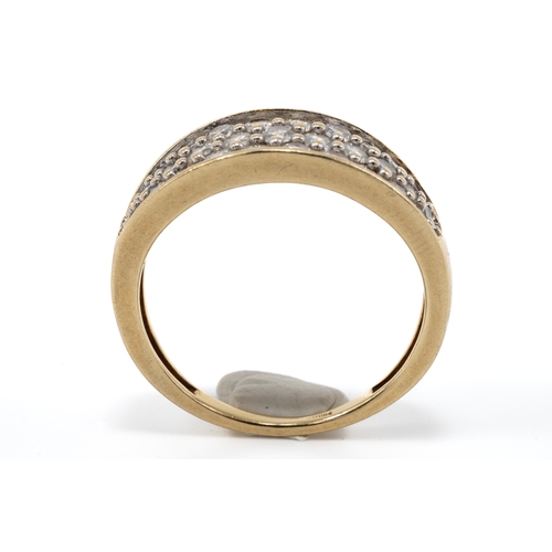 11 - A 9ct yellow gold and diamond ring, the boat shaped head set with three rows of round brilliant-cut ... 