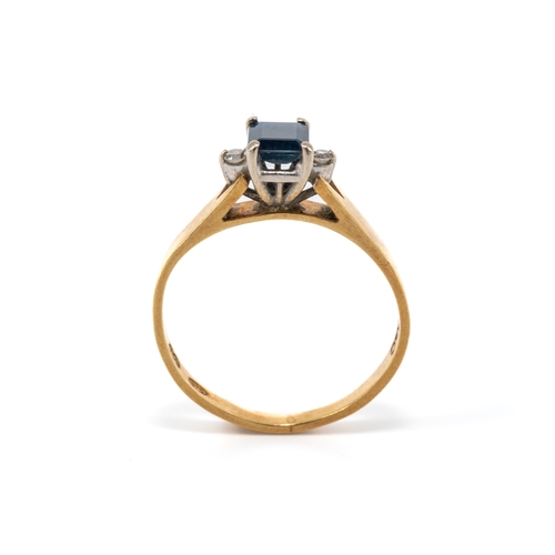 22 - A gold sapphire and diamond ring, the central square-cut sapphire flanked by two round brilliant -cu... 