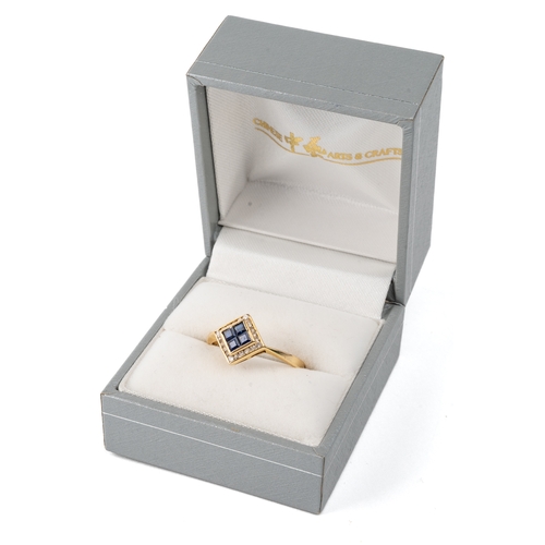 33 - A 14k yellow gold sapphire and diamond ring, set with four square-cut sapphires surrounded by cubic ... 