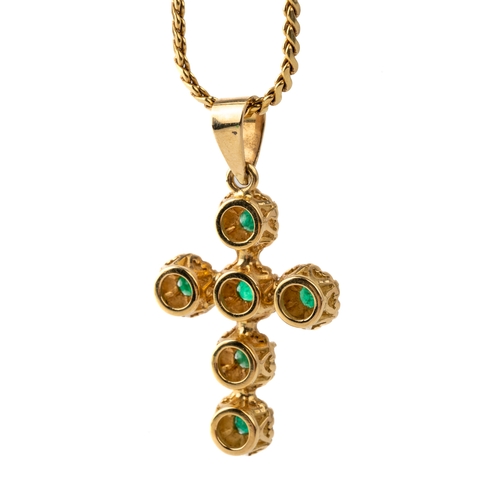 45 - A yellow metal and emerald cross pendant, set with round-cut emeralds in claw settings, unmarked ass... 