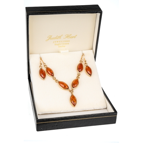 56 - A 9ct yellow gold and amber necklace and earrings set, the necklace set with five marquise cabochon ... 