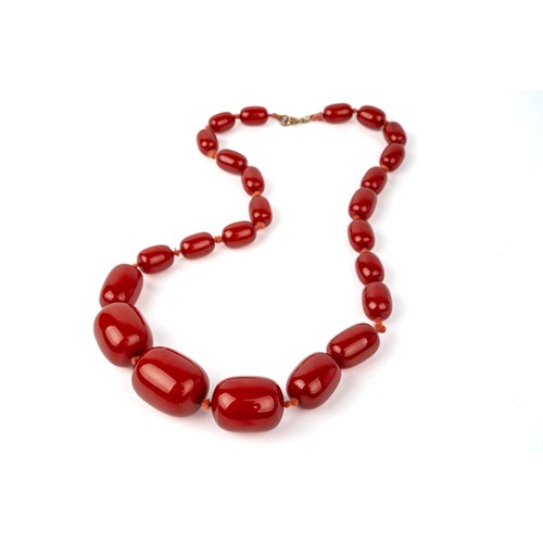 62 - A cherry amber bead necklace, weight 60g, largest bed measures approx. 27mm x 20mm, grain visible un... 